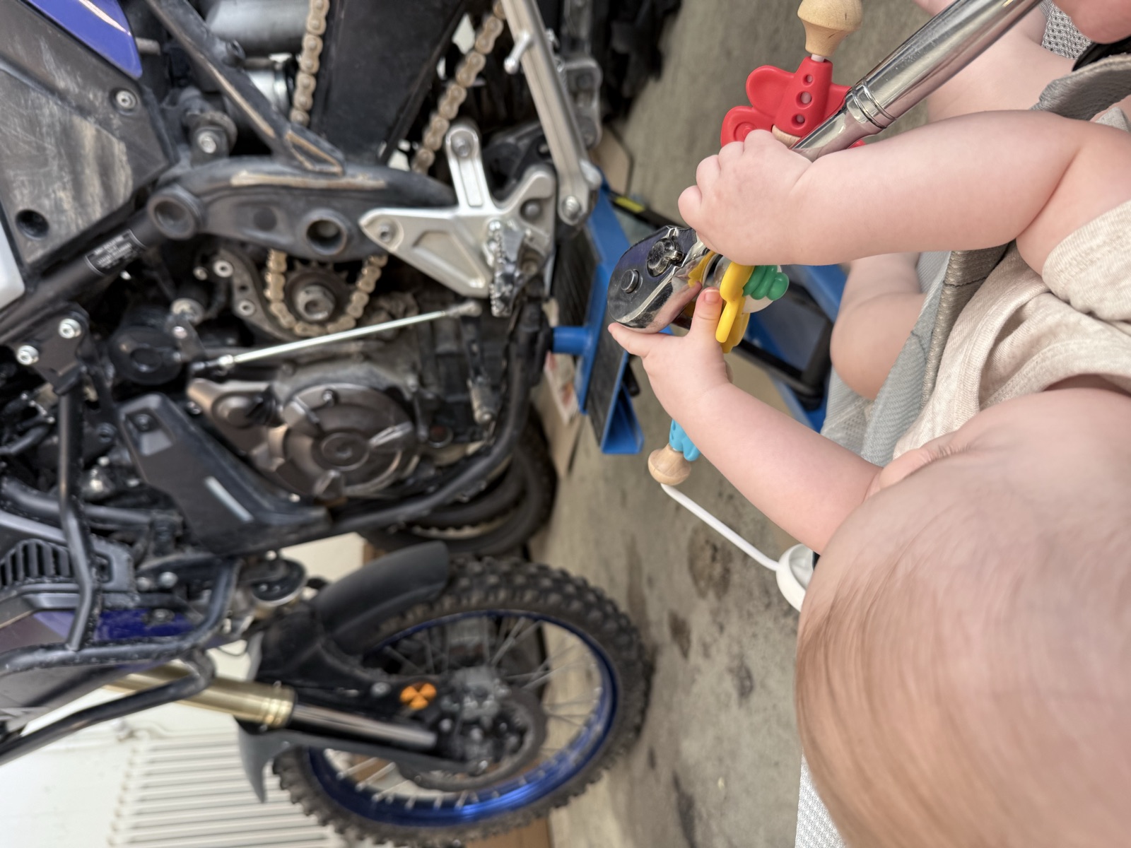 Rowan's young son helping him prepare the motorcycles